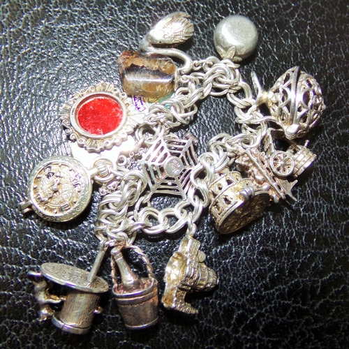 33 - Very unusual silver charm bracelet marked silver comprising of various charms Inc. cart , swan, cham... 