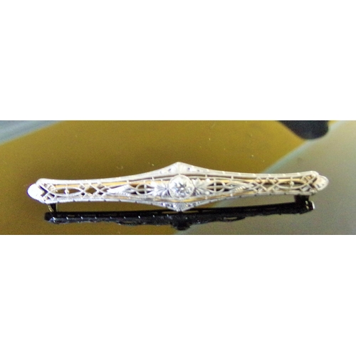 47 - An Edwardian diamond set filigree bar brooch, comprising a central old cut diamond weighing approx. ... 