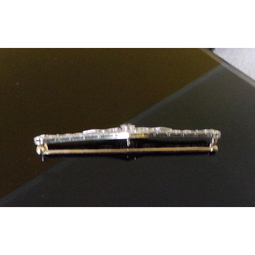 47 - An Edwardian diamond set filigree bar brooch, comprising a central old cut diamond weighing approx. ... 