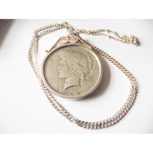 64 - 1922 silver dollar coin encased in white metal mount on white metal chain.