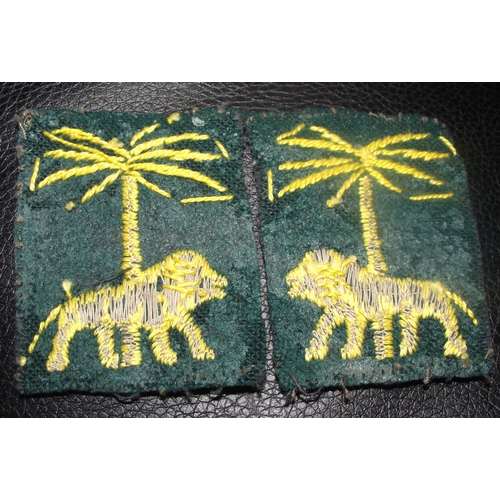 30 - Singapore district patches showing a lion under a palm tree. Also used by British forces in Sierra L... 