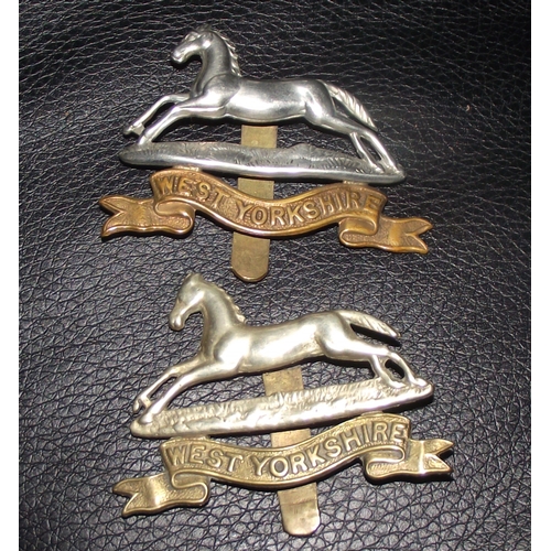 33 - 2x West Yorkshire regiment cap badges