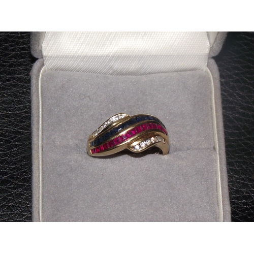 42 - 18ct gold ladies ring marked 750 set with rubies emeralds and diamonds in a crossover design size N ... 