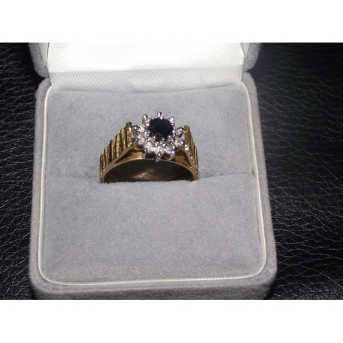 48 - 18ct gold fully marked diamond sapphire cluster central sapphire surronded with diamons on a raised ... 