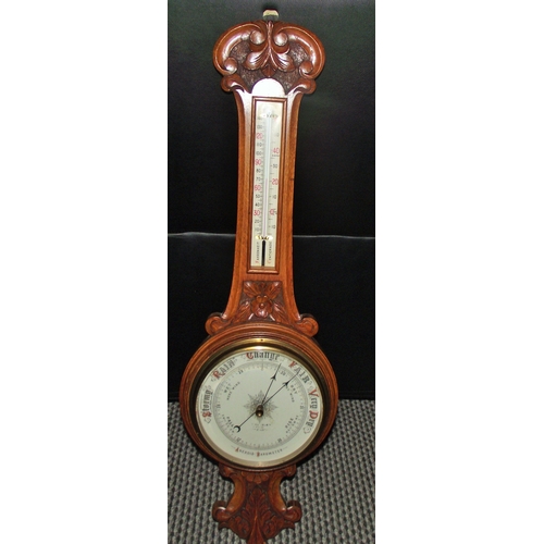 95 - Quality Edwardian Carved Oak Barometer and Thermometer Circa 1910 oak frame with foliate carving to ... 