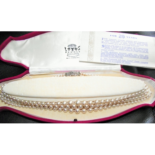 36 - cased se t 3 strand simulated pearls with silver diamante clasp in original box with gaurantee