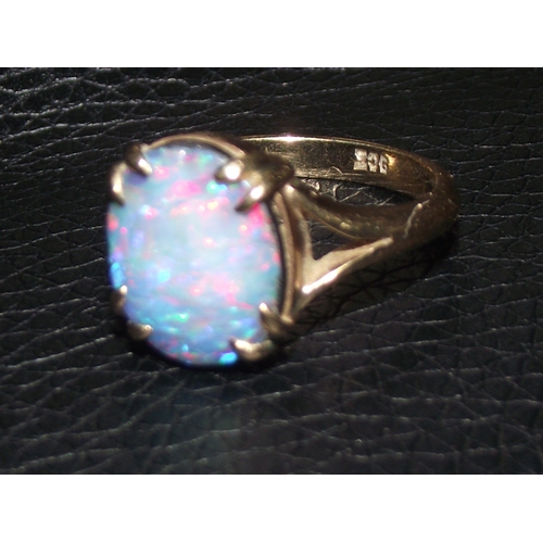 33 - Ladies 9ct gold opal set ring showing blues and red colouring claw set size L 3.48 g approx