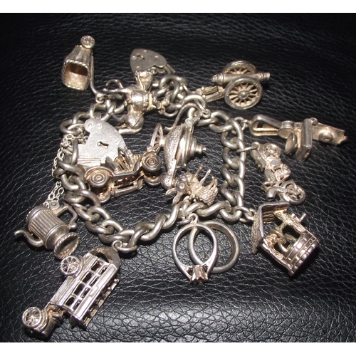 40 - Silver charm bracelet marked on each link with various charms 73g approx