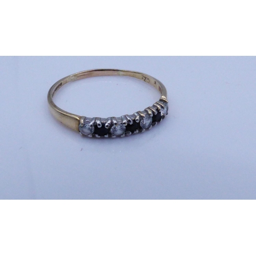 42 - Gold 375 Shared Prong Setting Black and Clear stoned Ring Size N
1.0 grams