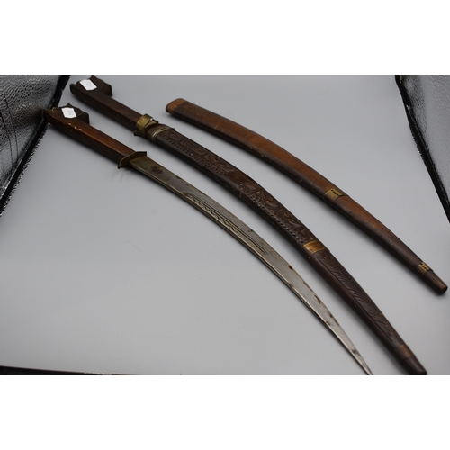 113 - Pair of African Nimcha Daggers 43cm long, both in Carved Wood Scabbards