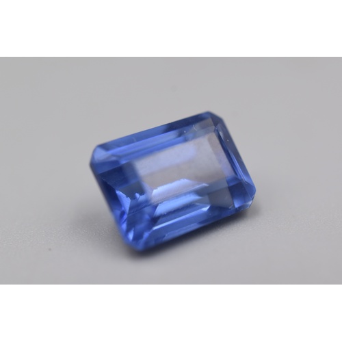 101 - Natural Blue Tanzanite in Emerald Cut (8.8ct) Complete with Certificate of Authenticity.