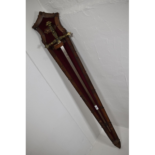 107 - Vintage sword with brass hilt. Etched decoration on the blade. Mounted on a leather and velvet cover... 