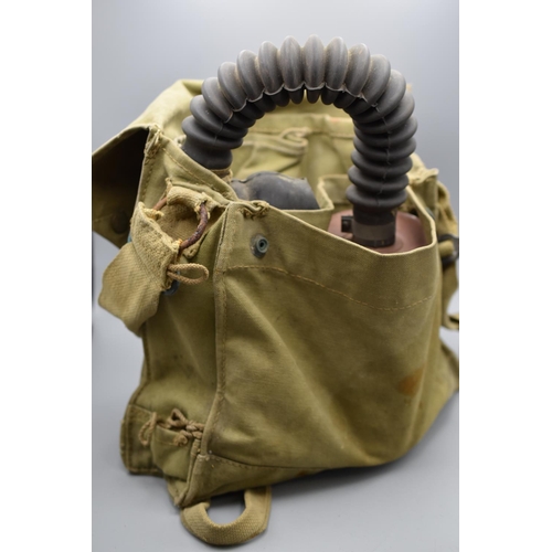 140 - WW2 British military gas mask in a canvas bag dated 1942