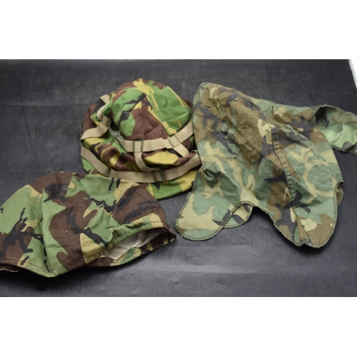 187 - Three different US and British camouflaged steel helmet covers