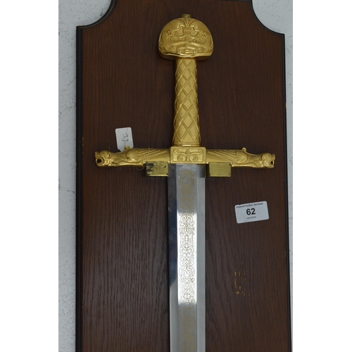 62 - The sword of Charlemagne with an ornate gilt hilt. Mounted on a plaque.  Sword 97cm long