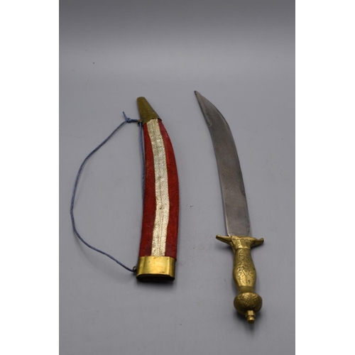 104 - Indian dagger with an etched blade, brass hilt and red velvet covered sheath