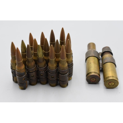 109 - Military inert bullet belt plus two larger shell cases