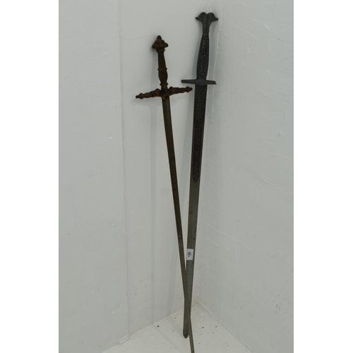 130 - Two swords with decorated blades. Both with damaged hilts. Largest measures 102cm long