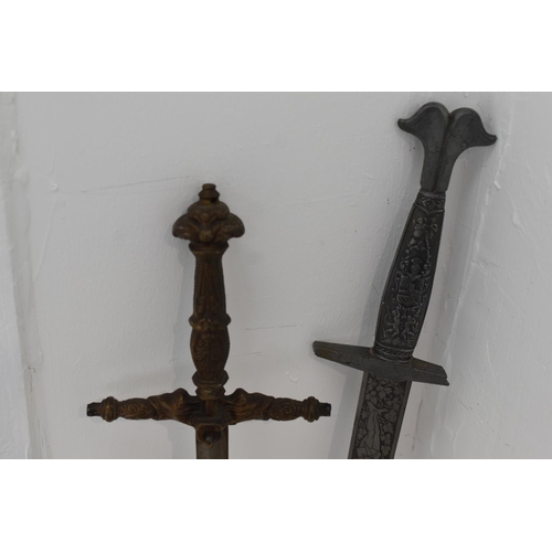 130 - Two swords with decorated blades. Both with damaged hilts. Largest measures 102cm long