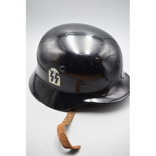 139 - German steel helmet with liner and chin strap. Shell stamped 