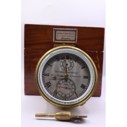 153 - Brass gimbal mounted ships clock with key. Complete with the original glass topped mahogany case wit... 