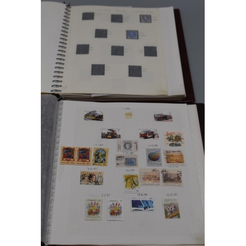 81 - Two Stanley Gibbons Albums Containing Stamps From Scotland, Northern Ireland, Wales, and Australia.