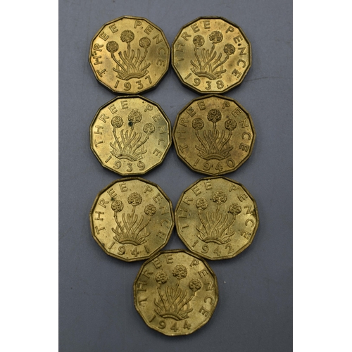 76 - Selection of Seven Brass George VI Three Pence Coins . Dated 1937, 1938, 1939, 1940, 1941, 1942 and ... 