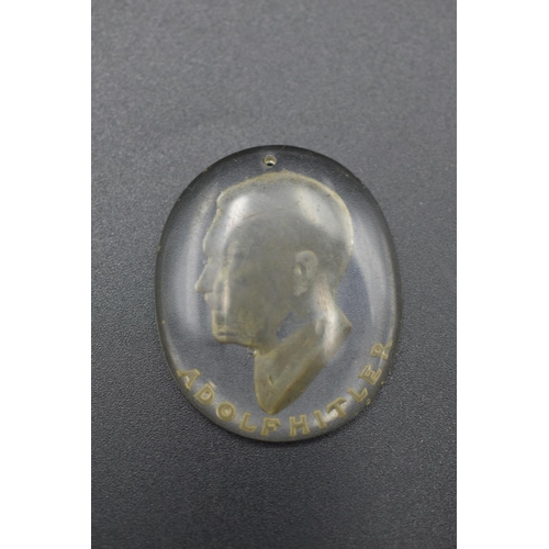 151 - WWII Nazi German Adolf Hitler Portrait Glass Pendant. 3.5cm Long and 3cm Wide. Portrait cut out of b... 