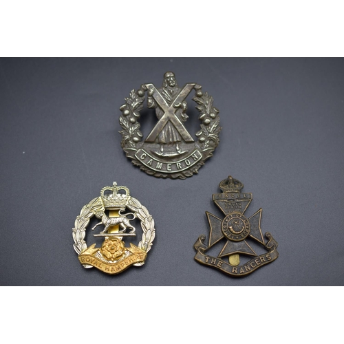 161 - Three Military Badges Including The Royal Hampshire, The Rangers and The Queens Own Cameron Highland... 