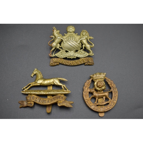 176 - Three Cap Badges, includes York & Lancaster, Manchester and West Yorkshire