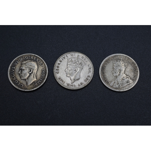 69 - Three Silver Coins 
George VI x3 NFL 10 Cents (1945) 
Canada 10 Cents 1944 and a George V Canada 10 ... 