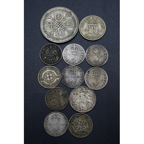 54 - A Selection of Twelve Silver Coins To Include Nine Threepences (1909-1938), 1943 Sixpence, Swiss 1/2... 