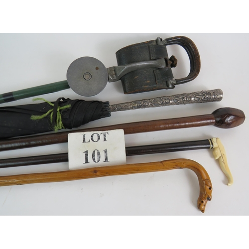 101 - A selection of sticks and canes including an antique  ivory and ebony elephant, dog's head, Eastern ... 