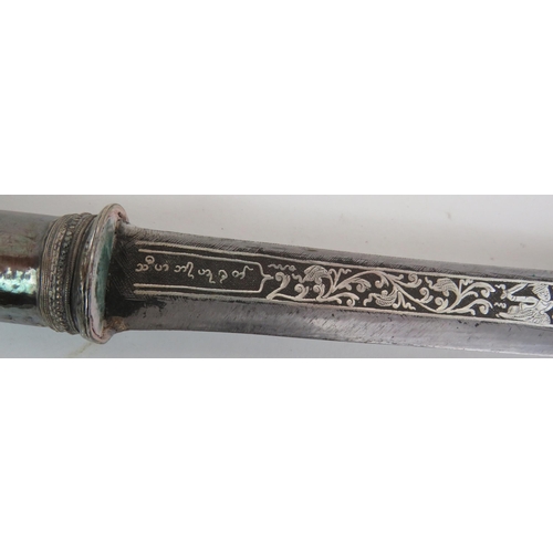 106 - A traditional Burmese Dha sword and scabbard with decorated white metal hilt and intricately decorat... 