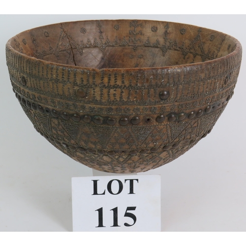 115 - An antique Indo-Persian carved hardwood bowl with steel pinwork and brass stud decoration. Diameter ... 