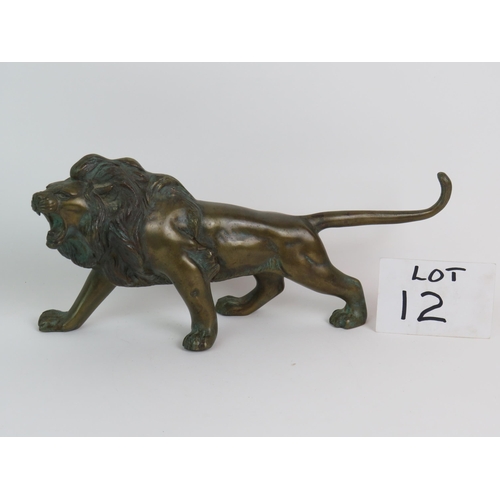 12 - A well cast patinated brass/bronze figure of a roaring male lion, 37cm long, 17cm high. Condition re... 