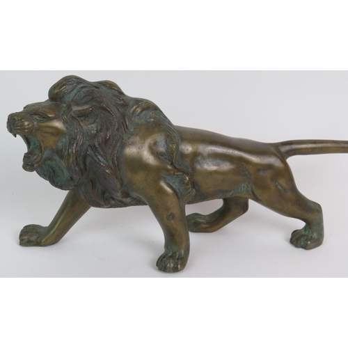 12 - A well cast patinated brass/bronze figure of a roaring male lion, 37cm long, 17cm high. Condition re... 