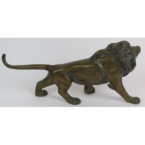 12 - A well cast patinated brass/bronze figure of a roaring male lion, 37cm long, 17cm high. Condition re... 