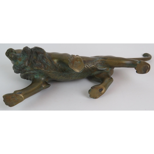 12 - A well cast patinated brass/bronze figure of a roaring male lion, 37cm long, 17cm high. Condition re... 