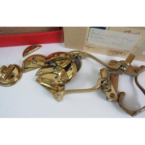 123 - Two boxes of salvaged brass door and window fittings including knob sets, escutcheons, sash locks et... 