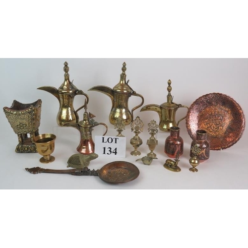 134 - A selection of Eastern brass and copper wares including four Dallah coffee pots, four Kohl bottles. ... 