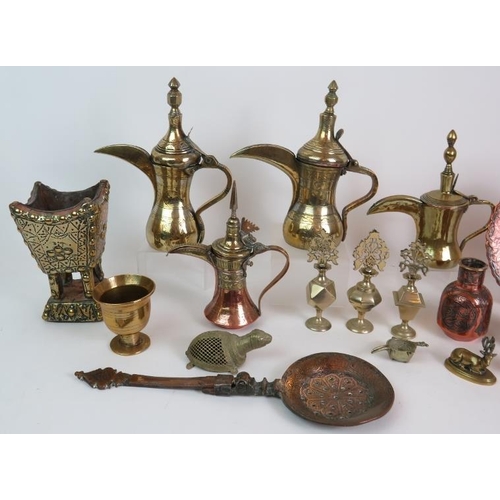 134 - A selection of Eastern brass and copper wares including four Dallah coffee pots, four Kohl bottles. ... 