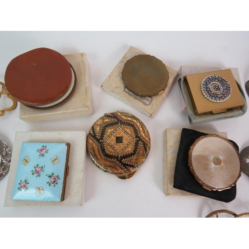 139 - Six vintage powder compacts including Stratton and an enamelled example plus six large belt buckles.... 