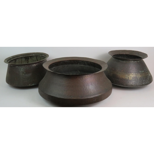 147 - Three decorative Eastern beaten copper pots of graduated size, ideal for logs! Largest 42cm diameter... 