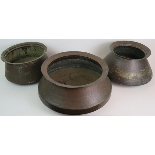 147 - Three decorative Eastern beaten copper pots of graduated size, ideal for logs! Largest 42cm diameter... 