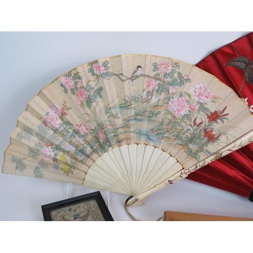 160 - Two hand painted Chinese fans, largest 72cm, and two hand stitched Chinese silk panels in frames, la... 