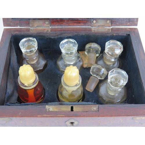 161 - An antique brass inlaid rosewood perfume box with internal mirror and divisions for 6 bottles plus a... 