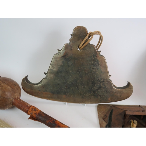 163 - A large bronze Eastern bell, a leather bound wooden club, an Eastern bronze gong, bone fly swat, tre... 