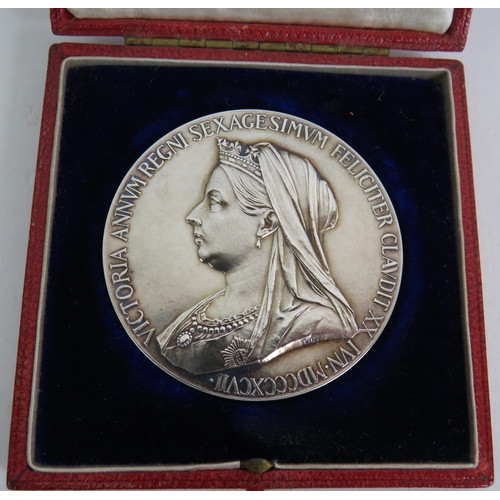 165 - Two Queen Victoria 1887 Jubilee medallions, one cased, an enamelled half crown brooch, two relief pl... 