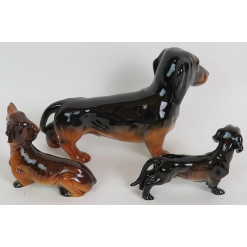 167 - A Beswick pottery Dachshund sausage dog 22cm long and two smaller similar pottery Dachshund dogs. (3... 